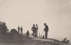 This image depicts a group of people standing on a hill. The dark figures and landscape contrast with the vast empty sky behind them.