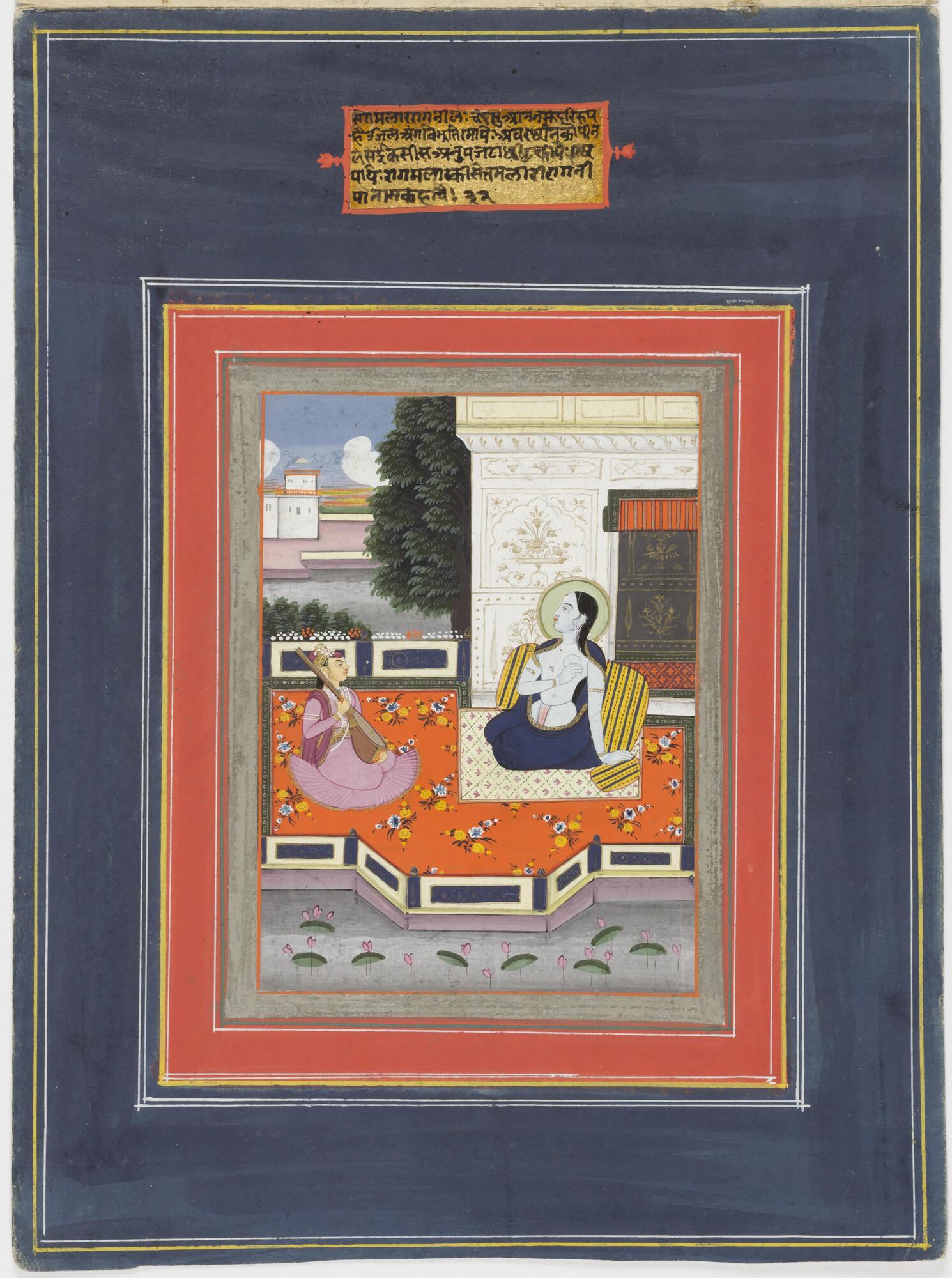 A blue-skinned female sits on an open-air terrace, behind her is a pavilion. Another female (?) figure is seated beside her, playing a stringed instrument, possibly the veena. A short verse is painted above the depicted scene.