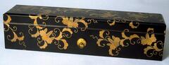 The long rectangular box with detailed floral patterns in lacquer on a black background. Part of a bridal trousseau.