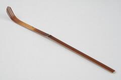 Long, slender tea scoop with elongated scoop area. Red inscription on back, wooden with semi-gloss finish.