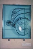 A polyurethane relief sculpture of the front end of an automobile superimposed over a silkscreen image of the car in an aluminum frame.<br />