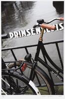 Image of a bike leaning against a railing with water in the background.&nbsp;