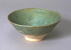 A deep bowl with incised floral patterns.