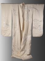 Japanese kimono made with light pink color silk. It has silver sewings with pattern of flowers on it.