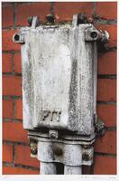 Image of a metal utility box on a red brick wall.&nbsp;