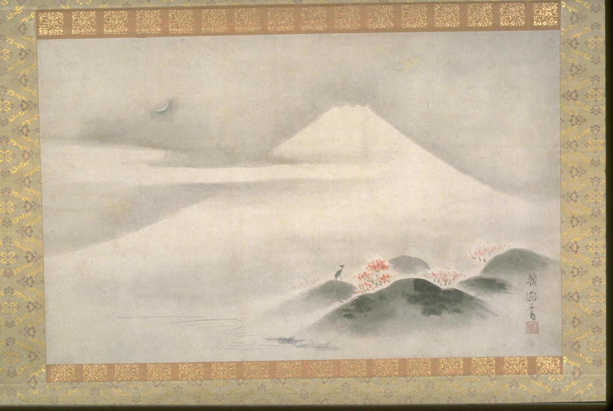 In the center of this painting, there is Mt. Fuji. Next to the peak of the mountain, to the left of the painting, there is a crescent moon and clouds. To the bottom right of the painting, there are green hills with trees that have red fall leaves on them. Next to these trees, there is one lone deer looking up to the sky. At the bottom of the Mountain, there is a river.