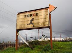 A sign that reads "Force" by railroad tracks.