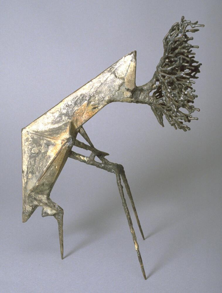 This small sculpture resembles a grasshopper-like insect standing on three legs, but instead of a head a branching form resembling tree roots emerges from the top of the sculpture.