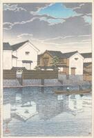 A man stewards a narrow boat carrying a passenger along a river. The houses and walls alongside reflect on the river's surface. The sky is nearly covered by gray clouds, but small patches of blue sky shine through.