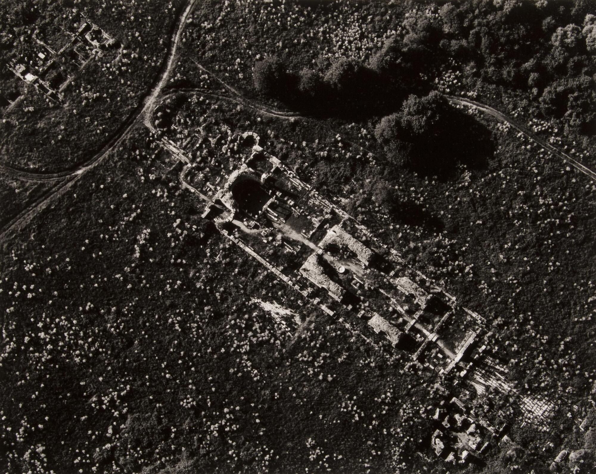 This photograph depicts an aerial view of the ruins of a church within an ancient city.