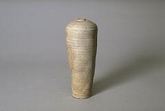 A loosely wheel-thrown, gray stoneware, unglazed vase of <em>meiping</em> (梅瓶) form, tall and tapered with coarse inclusions. It has wide shoulders and a narrow mouth with a small neck. Uneven contour and visible throwing lines leave a ribbed surface, showing kiln effects. 