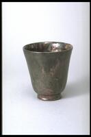 Cup-shaped vessel with foot covered with a semi-matte creating a mottled effect in muddy shades of rose and green