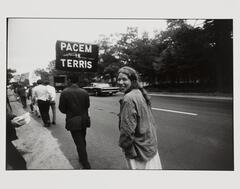 Photograph of a group of protesters walking in a line along the side of road.