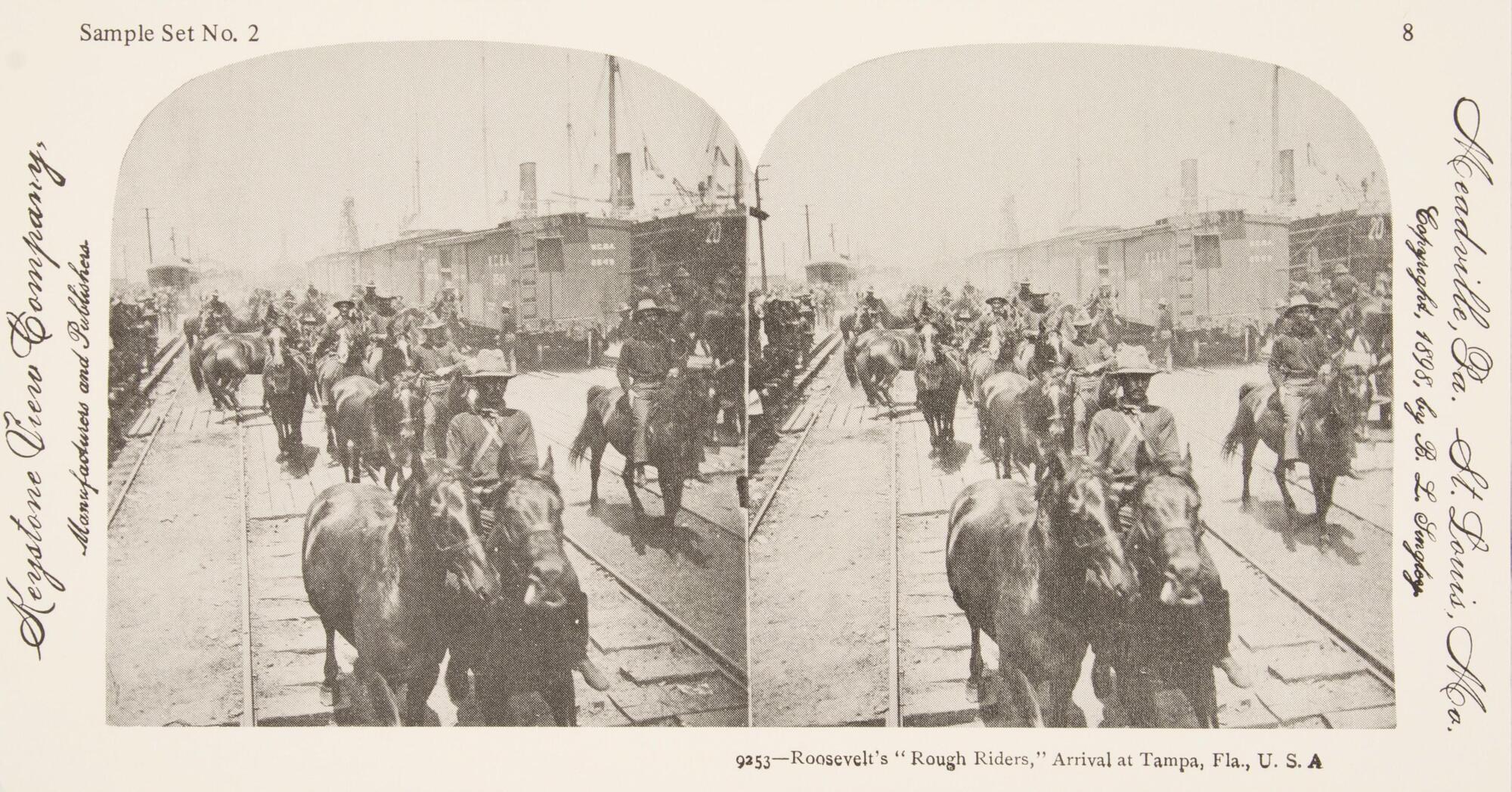 This black and white stereoscopic image features two images of a train station filled with horses being escorted by men.