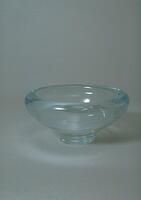 Clear glass bowl-shaped vessel with large foot and turned-in lip.