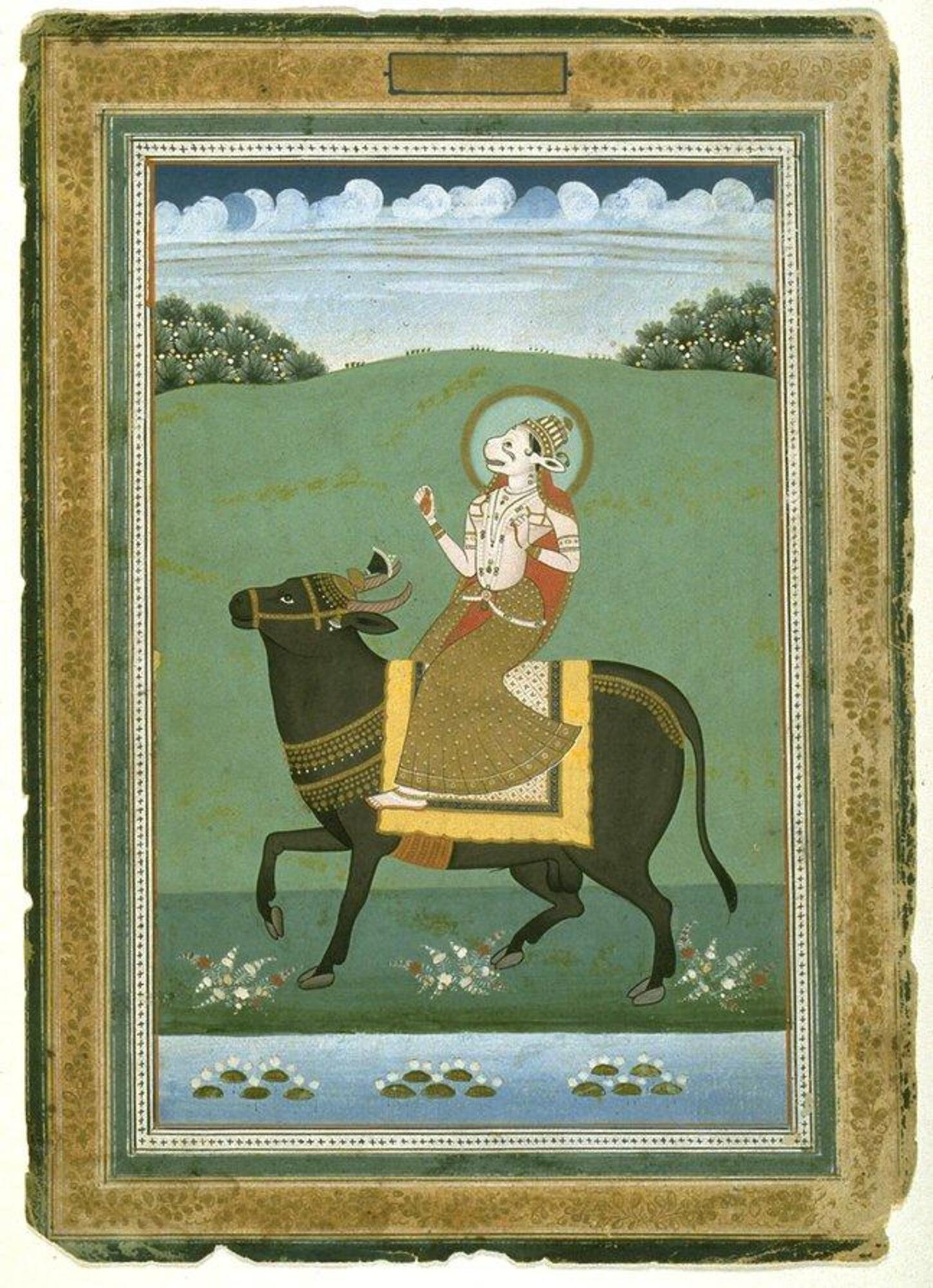 Two figures, Anjana and a bull are depicted centrally in the image. The background is very simple with some grass tufts and a pond near the very bottom of the images. Near the top of the image in the background there some trees and sky are visible.