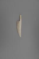 A small knife carved from ivory that fits into the hole in the hunter&#39;s right hand on Man Fighting Polar Bear.&nbsp;
