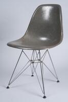 Dark gray-green side chair consisting of a single plastic "shell" mounted on a wire rod base.
