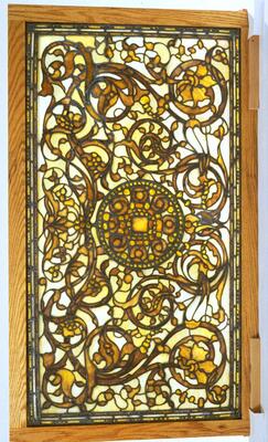 White and amber glass (including carbochon pieces) are arranged in a horizontal composition of arabesque design.