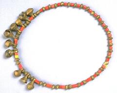 Belt made from brass, orange, and yellow beads with small crotal bell pendants.