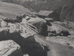 Wooden footbridge in a mountain valley.