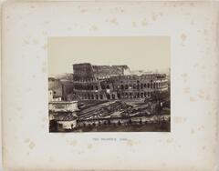 Elevated view of the Colosseum in Rome, seen from a distance.