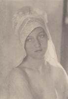 This image is a softly-focused portrait of a young woman wearing a bonnet. She gazes into the distance toward the left side of the frame.