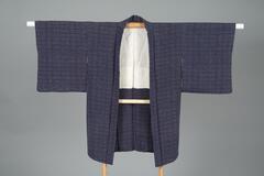 <p>Dark blue haori with intervoven white dot patterning with a white lining with dyed pale patterning.</p>
