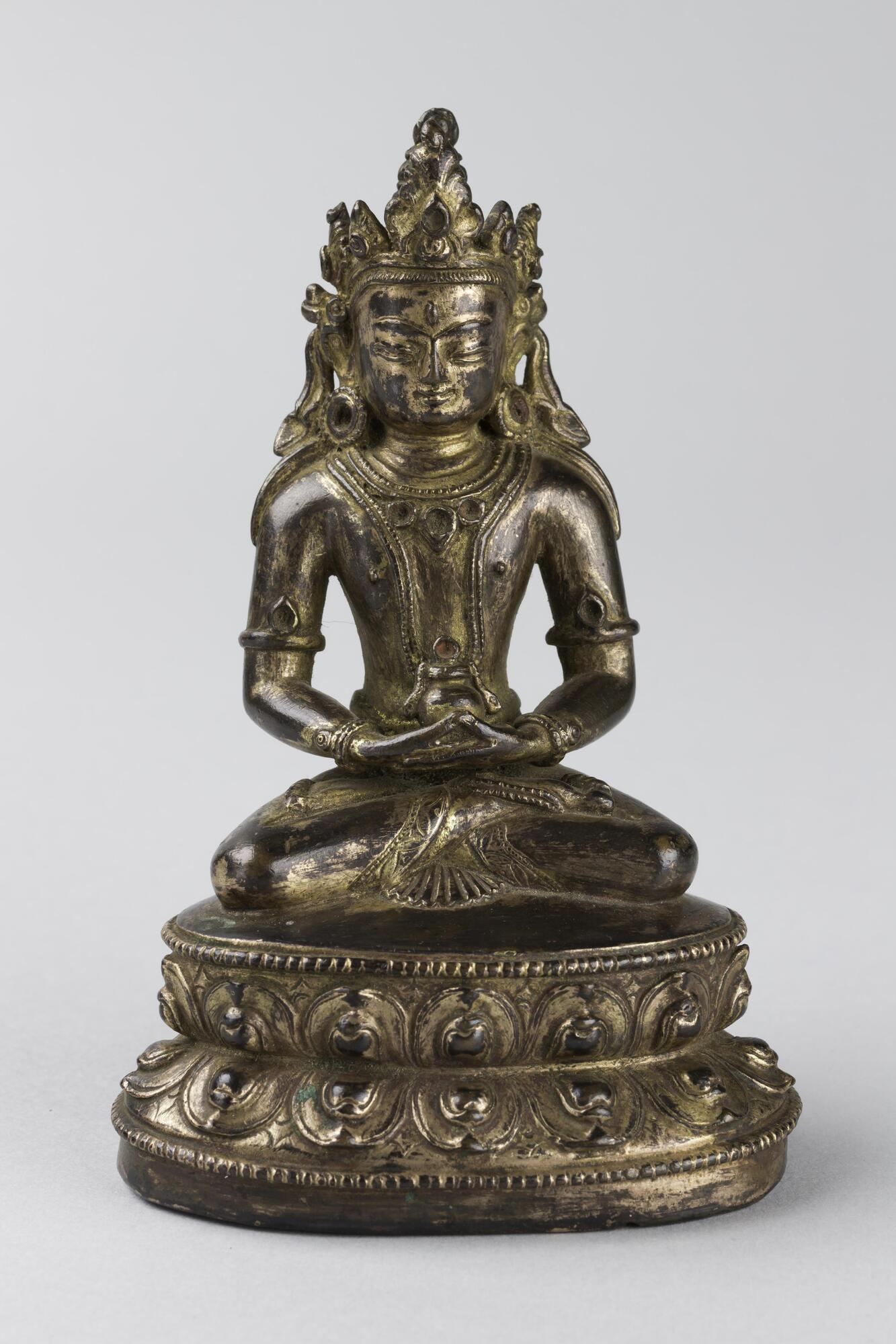 A finely cast miniature icon of the Buddha Amit&acirc;yus, seated on a double lotus pedestal.