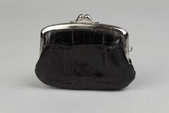 A small black handbag made of alligator leather and fabric. The top edges are silver metal.
