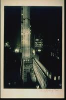 Elevated view of Rockefeller Center illuminated at night by artificial lights.