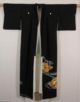 Black silk crepe with yuzen (paste-resist hand-painted), surihaku (silt) and embroidered designs. Five crests done in reserve (appears as white on black). Lining is plain-weave white satin for the entire length of the kimono. Collar, upper torso, and sleeves have a double lining.