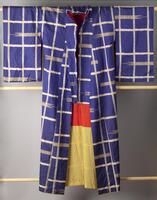 Female dark blue kimono with woven ikat design in tan collar.  Lining is red and yellow.