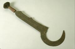 A knife with a wooden, wire-wrapped handle with a conical pommel. The blade near the handle is straight with two small points along one side and sickle-shaped at the top. 