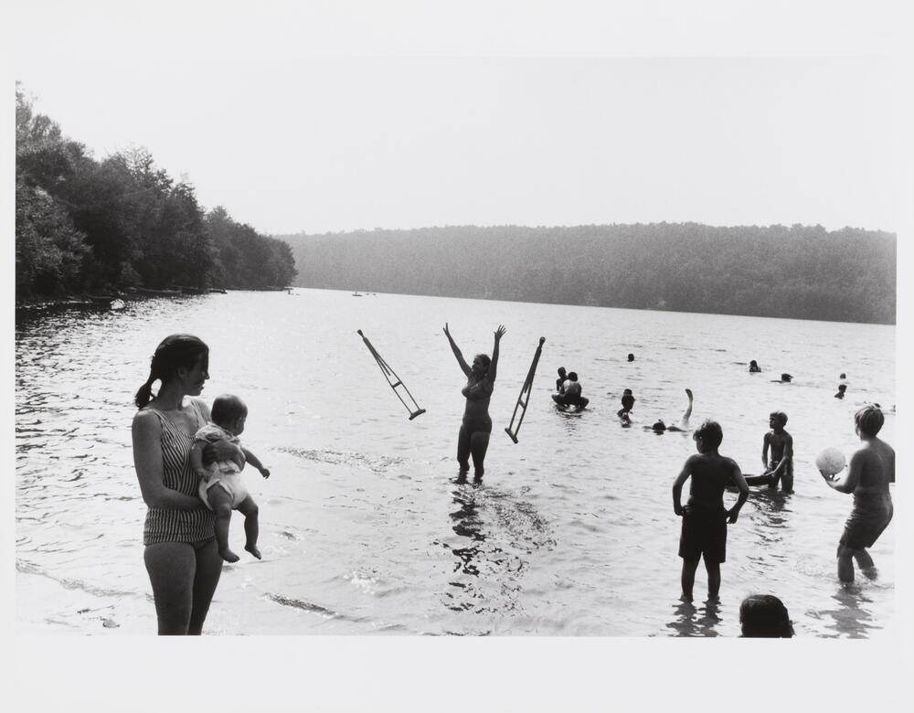 Group of women and children playing in the shallows.