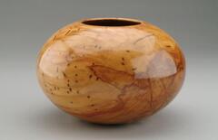 highly polished round wood vessel
