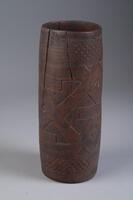 Barrel form cup with handle. Geometric pattern consisting of multiple intersecting lines. There is a crack from the top running vertically down the cup.&nbsp;