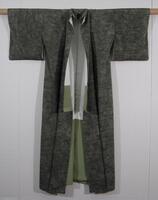 White silk crepe with mottled green ground and white lines achieved through hand-applied discharge paste (hako roketsu).  Lining is plain weave silk, white above and green below.
