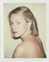 A bust-length portrait of a nude woman with her blonde hair pinned back on one side. She faces her body toward the left side of the frame, turning and tilting her head toward the camera.