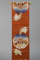 <p>Red fukuro (singe-sided) obi with embroidered white, orange, and blue rounded peonies and butterflies with gold and silver embroidery.</p>
