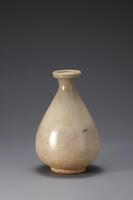 Produced at regional kiln in the 17th and 8th centuries Joseon, this white porcelain bottle is stable and balanced in form. It was made from iron-rich clay which tinged the bottle with gray-white, a common characteristic of 17th century white porcelain. The glaze on the upper part is transparent and shiny, but that on the lower part was not fully melted, producing a rough texture. The foot exposes the clay body as the glaze was wiped away from the bottom of the foot.<br />
[Korean Collection, University of Michigan Museum of Art (2014) p.176]