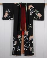 This black silk crepe kimono is decorated with chrysanthemum motifs, and has an inner red lining.