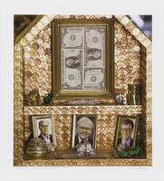 Image of a small wood structure, covered in pennies, containing framed dollar bills, coins, jewels, and photos of Warren Buffett, Bill Gates, and Amancio Ortega.&nbsp;