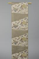 <p>cream and beige fukuro obi with interwoven gray-blue, pale red and yellow, and beige alternating seigaiha (wave crest) motif patterning, mountains, pine, bamboo, waves, orchids, (house/shack), and autumnal foliage motif patterning imitating bingata-like (Okinawa textile) &nbsp;dyeing process.</p>
