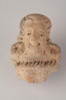 Indian terracotta sculpture of a man's head, craft in details with eyes, nose, mouth and hair.