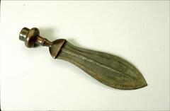 Knife with a leaf-shaped blade. The center of the blade has an engraved line running down the length of the blade. The handle has a bulb-like base flattened at the end. 