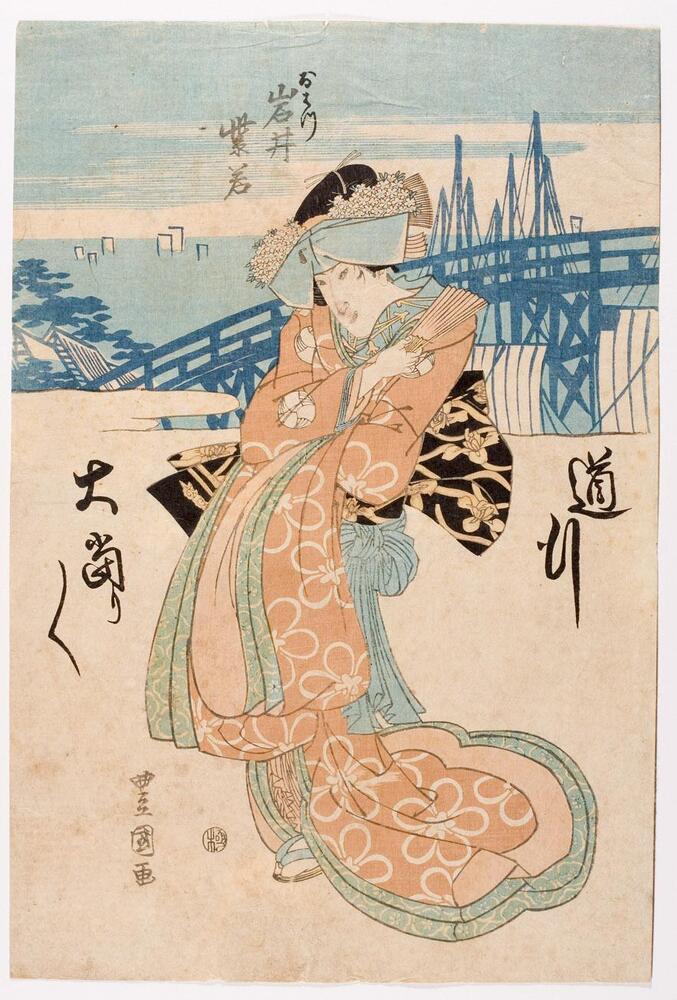 In this print, a woman stands holding a fan up to her shoulder.  She wears an orange robe with large white flower outlines and green borders.  Flowers decorate her hair.  In the background a bridge and the tops of ships are visible.<br />
 <br />
Inscriptions: Artist’s signature: Toyokuni ga; Censor’s seal: kiwame; Ohatsu, Iwai Shijaku; Michiyuki ōatari ōatari