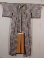 Light gray tango chirimen (silk crepe) damask with woven lozenge pattern; over this, paste-resist dyed "splotches" in blue, green and brown.  Finally, embroidered autumn flowers: ominaeshi, hagi, chrysanthemums.  Lining is plain weave silk, white above and butterscotch color below.
