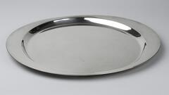Silver tray with a raised edge which is wider on the sides.&nbsp;
