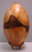 egg-shaped wood vessel on legs, with petal-shaped opening on top